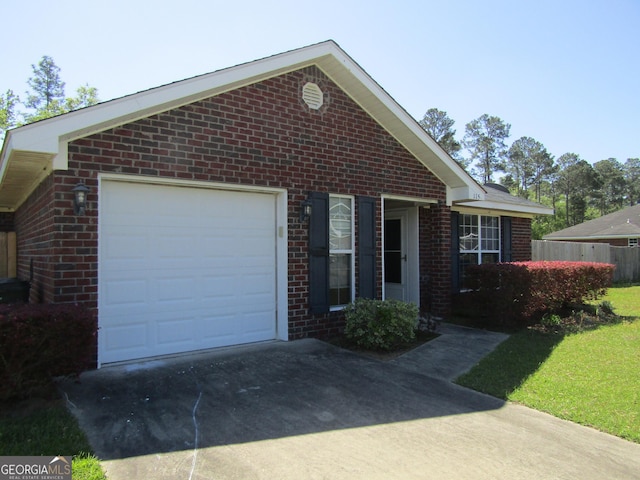 single story home featuring a garage, driveway, and brick siding