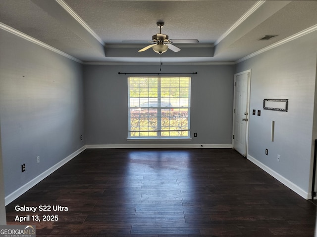 unfurnished room featuring crown molding, dark wood-style flooring, ceiling fan, a raised ceiling, and a textured ceiling