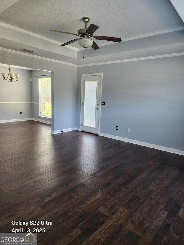unfurnished room featuring crown molding, ceiling fan with notable chandelier, dark wood-style flooring, and a textured ceiling