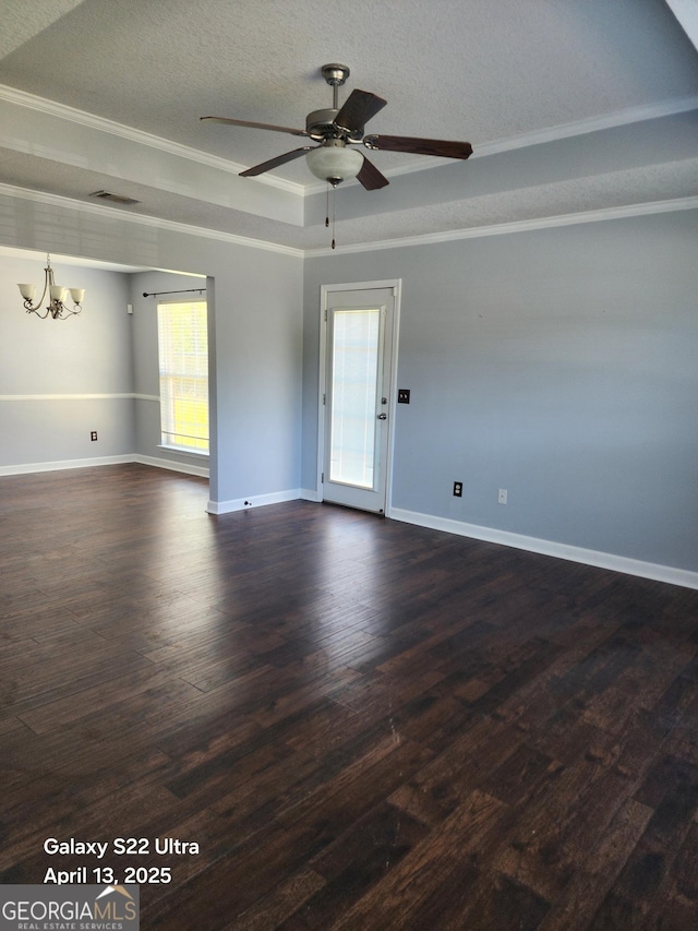 empty room with crown molding, baseboards, a textured ceiling, dark wood finished floors, and ceiling fan with notable chandelier