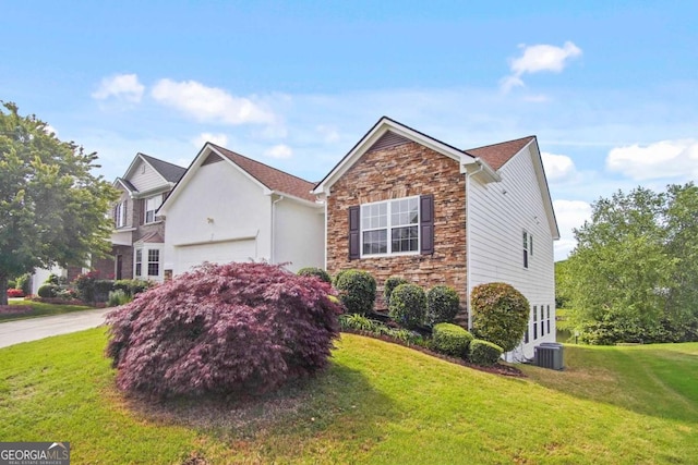 1544 Overview Cir, Lawrenceville, GA 30044 - view of front of property with stone siding, a garage, and a front lawn