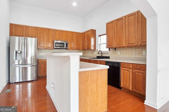 1544 Overview Cir, Lawrenceville, GA 30044 - kitchen with stainless steel appliances, a sink, light countertops, and wood finished floors
