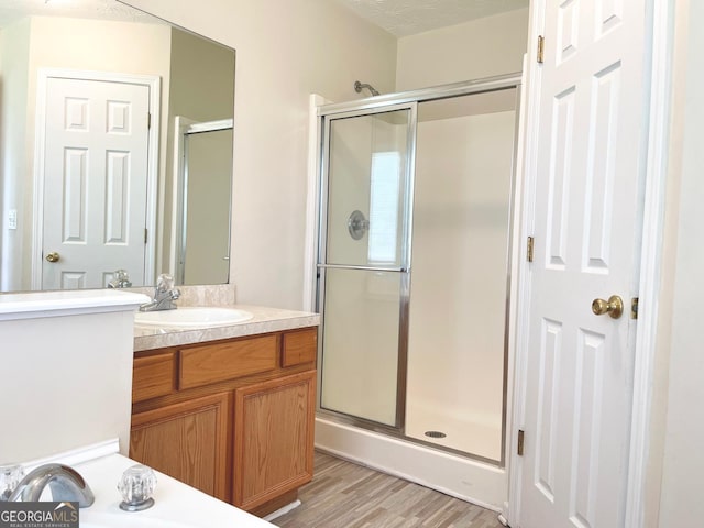 127 Mabry Rd, Jackson, GA 30233 - bathroom featuring vanity, a stall shower, and wood finished floors