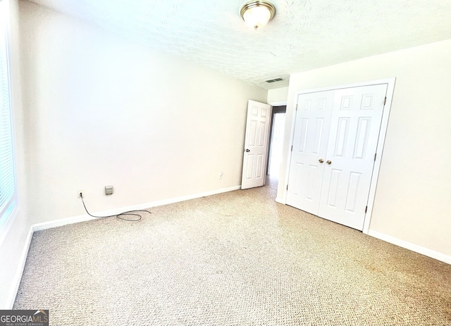 127 Mabry Rd, Jackson, GA 30233 - unfurnished bedroom with a closet, light colored carpet, and a textured ceiling