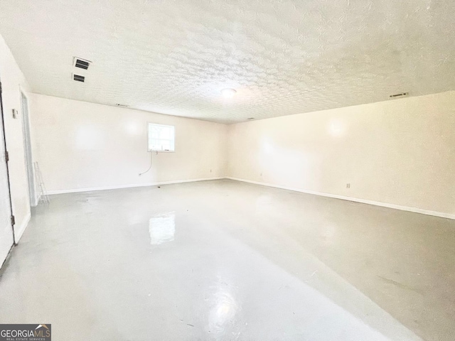 127 Mabry Rd, Jackson, GA 30233 - spare room with finished concrete flooring, a textured ceiling, and baseboards