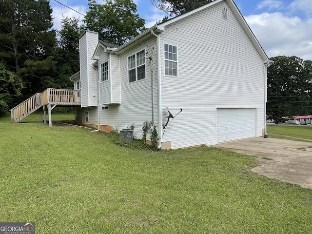 127 Mabry Rd, Jackson, GA 30233 - view of side of home with a chimney, concrete driveway, an attached garage, a deck, and a yard