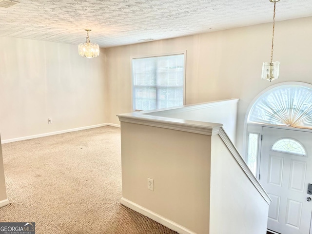 127 Mabry Rd, Jackson, GA 30233 - carpeted foyer featuring a chandelier, healthy amount of natural light, and a textured ceiling
