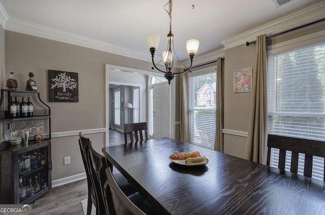 3186 Sail Winds Dr NW, Acworth, GA 30101 - dining room featuring crown molding, a chandelier, and wood finished floors