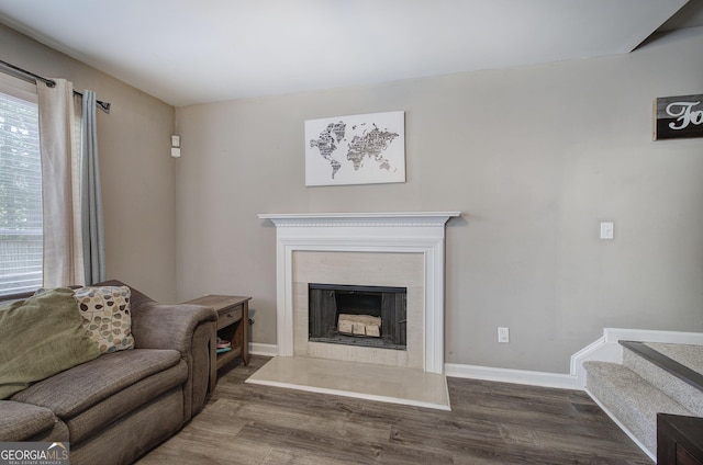 3186 Sail Winds Dr NW, Acworth, GA 30101 - living area with baseboards, a fireplace with raised hearth, stairs, and wood finished floors