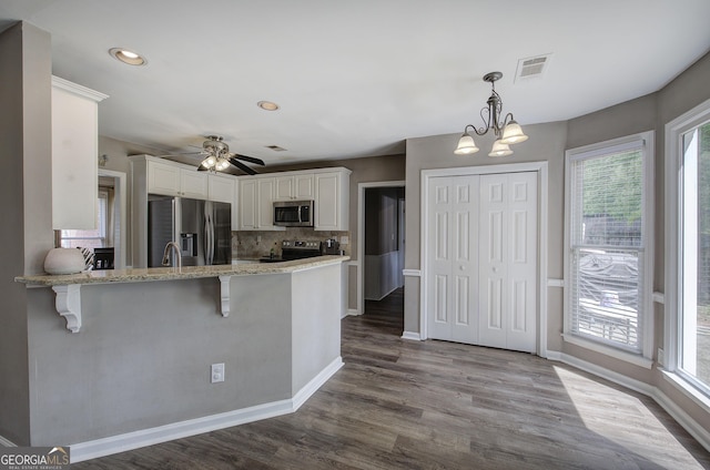 3186 Sail Winds Dr NW, Acworth, GA 30101 - kitchen with plenty of natural light, stainless steel appliances, a kitchen bar, and visible vents