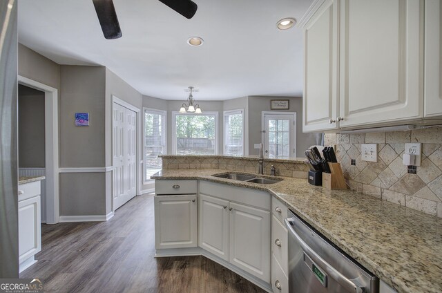 3186 Sail Winds Dr NW, Acworth, GA 30101 - kitchen with backsplash, stainless steel dishwasher, a sink, white cabinets, and a peninsula