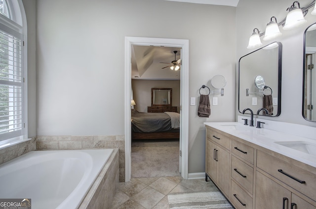 3186 Sail Winds Dr NW, Acworth, GA 30101 - bathroom with connected bathroom, a relaxing tiled tub, a sink, double vanity, and a ceiling fan