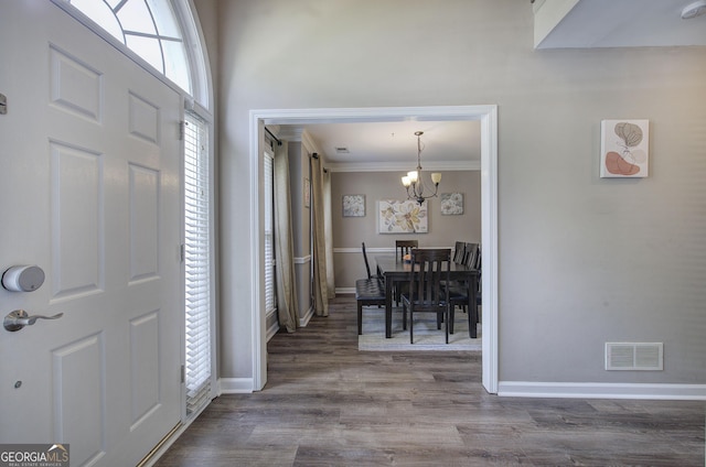 3186 Sail Winds Dr NW, Acworth, GA 30101 - entryway with a chandelier, wood finished floors, and crown molding