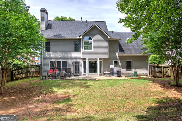 3186 Sail Winds Dr NW, Acworth, GA 30101 - rear view of property featuring a chimney, a patio, a fenced backyard, and a shingled roof