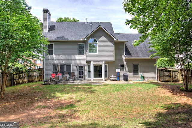 3186 Sail Winds Dr NW, Acworth, GA 30101 - back of house with a lawn, a chimney, a fenced backyard, and a patio area