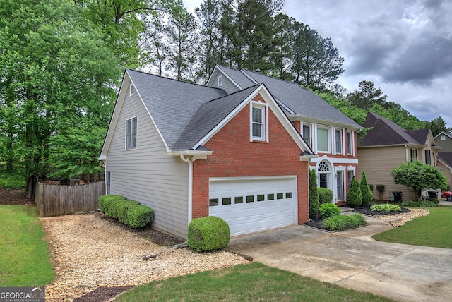 3186 Sail Winds Dr NW, Acworth, GA 30101 - traditional-style home featuring a garage, fence, brick siding, a shingled roof, and concrete driveway