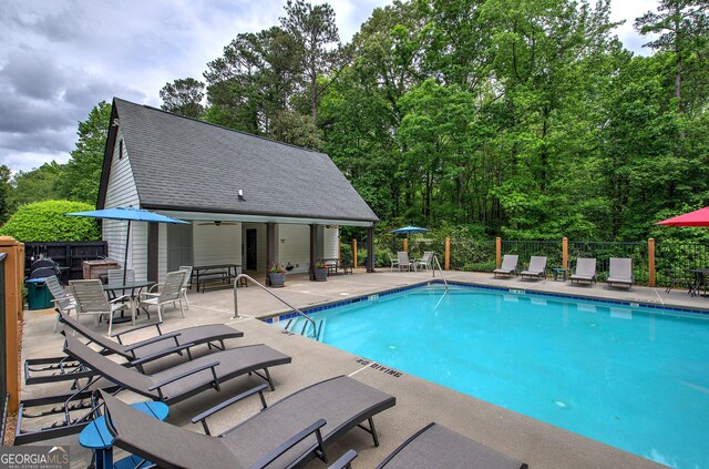 3186 Sail Winds Dr NW, Acworth, GA 30101 - community pool with a patio, fence, and an outbuilding