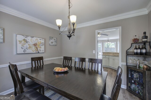 3186 Sail Winds Dr NW, Acworth, GA 30101 - dining room featuring dark wood-type flooring, baseboards, crown molding, and ceiling fan with notable chandelier