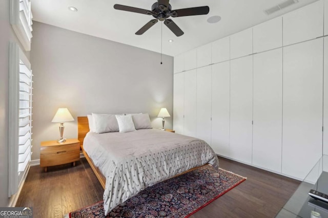 bedroom with visible vents, recessed lighting, and dark wood-type flooring