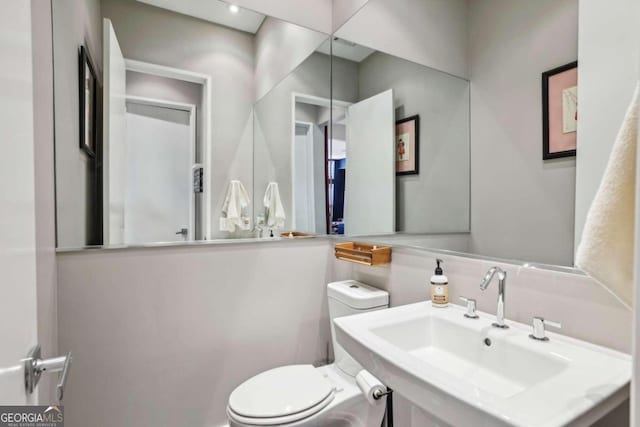 bathroom featuring toilet and a sink