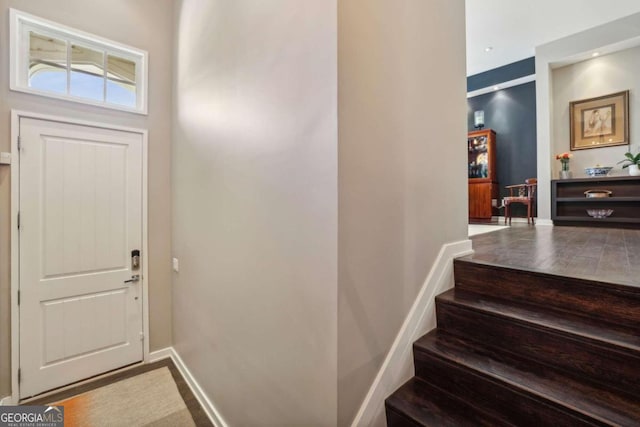 entryway featuring stairs and baseboards