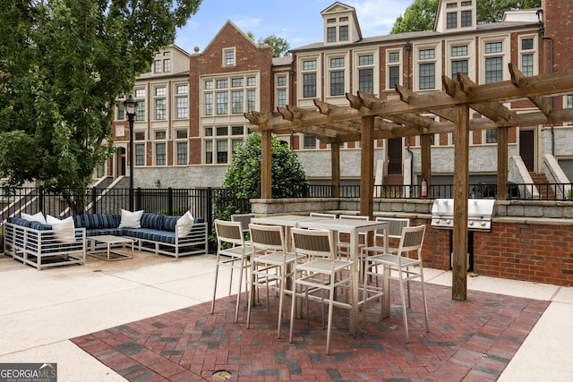 view of patio featuring a pergola, exterior kitchen, an outdoor living space, and fence