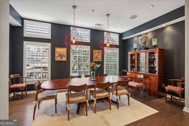 dining space with recessed lighting, wood finished floors, and visible vents