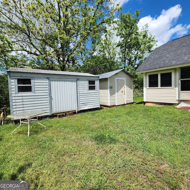view of yard featuring an outbuilding and a storage unit