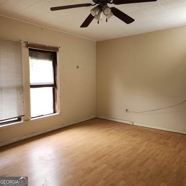 unfurnished room featuring a ceiling fan and wood finished floors