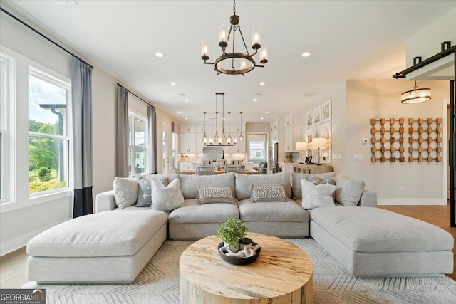 3525 Brynhurst Dr, Cumming, GA 30028 - living area featuring baseboards, a wealth of natural light, and an inviting chandelier