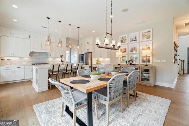 3525 Brynhurst Dr, Cumming, GA 30028 - dining space featuring an inviting chandelier, baseboards, light wood-type flooring, and recessed lighting