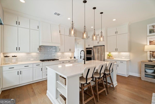 3525 Brynhurst Dr, Cumming, GA 30028 - kitchen featuring a sink, open shelves, a kitchen island with sink, visible vents, and appliances with stainless steel finishes