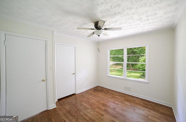 120 Hunt Rd, Athens, GA 30606 - unfurnished bedroom featuring a textured ceiling, a ceiling fan, baseboards, wood finished floors, and visible vents