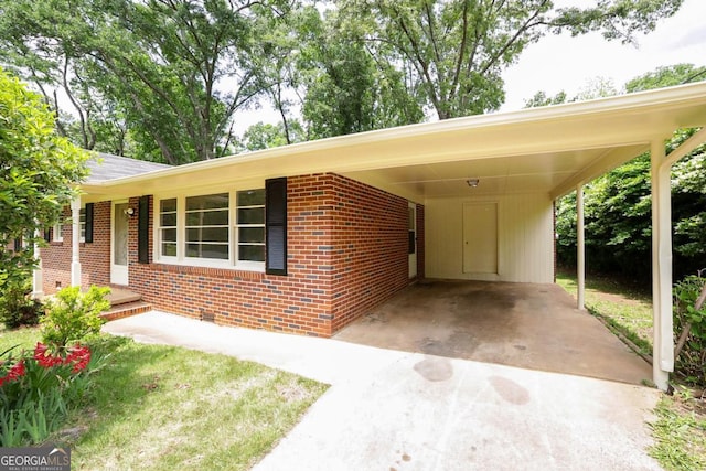 120 Hunt Rd, Athens, GA 30606 - view of front of home with concrete driveway, brick siding, and a carport