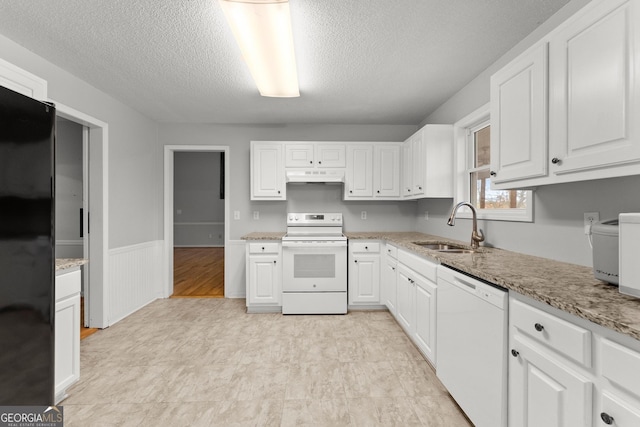 kitchen with a sink, white appliances, a textured ceiling, white cabinetry, and under cabinet range hood