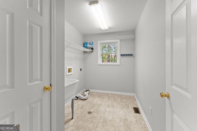 clothes washing area with washer hookup, hookup for an electric dryer, laundry area, a textured ceiling, and visible vents