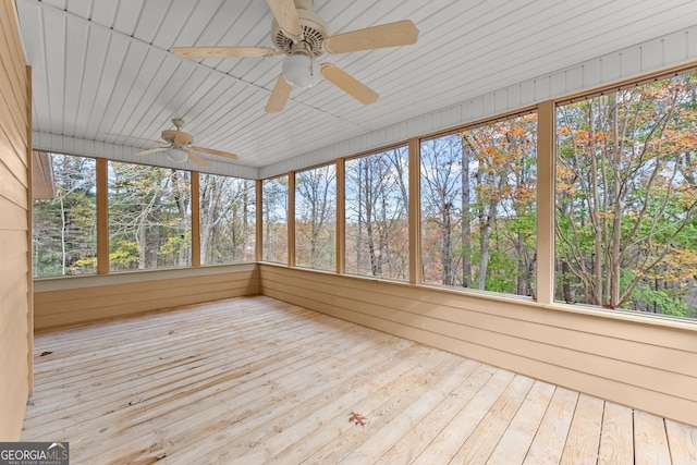 unfurnished sunroom featuring a ceiling fan