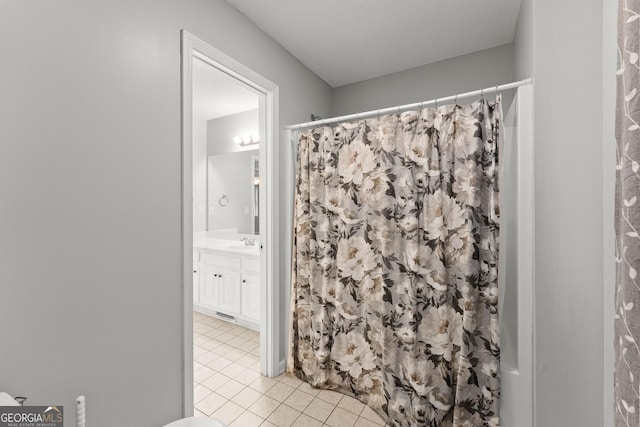 full bath featuring vanity, tile patterned floors, and curtained shower