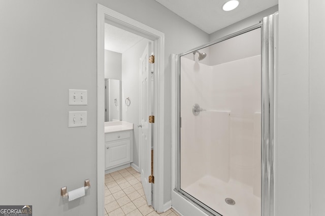 bathroom with vanity, tile patterned floors, and a stall shower