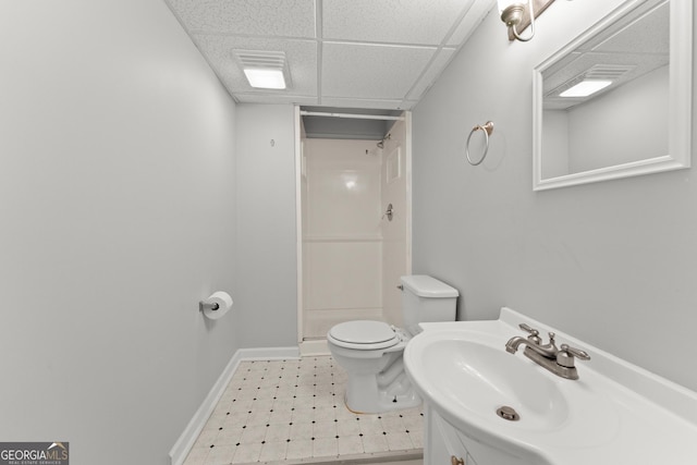 full bath featuring vanity, toilet, baseboards, a paneled ceiling, and a shower stall