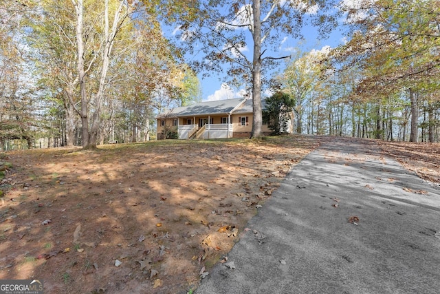 view of front of property with covered porch and aphalt driveway