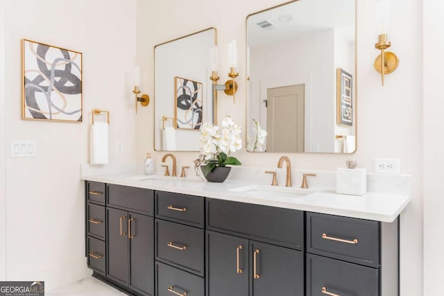 bathroom featuring a sink, double vanity, and visible vents
