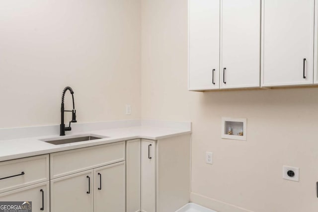 washroom featuring cabinet space, electric dryer hookup, a sink, and hookup for a washing machine