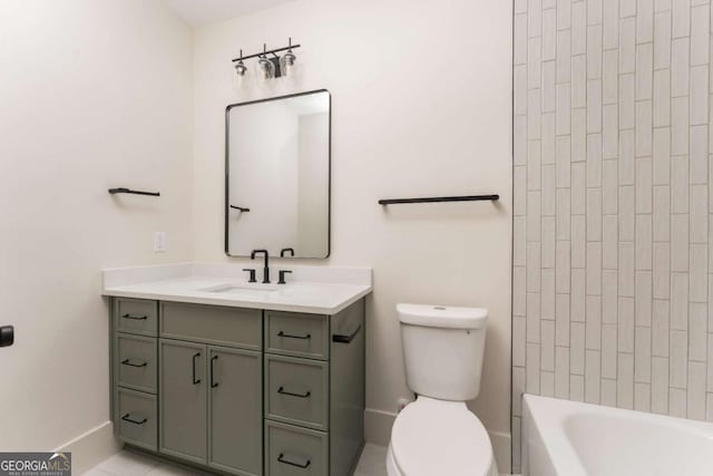bathroom featuring vanity, baseboards, and toilet