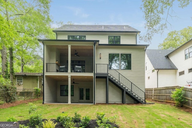 back of property with stairs, a ceiling fan, a fenced backyard, and french doors