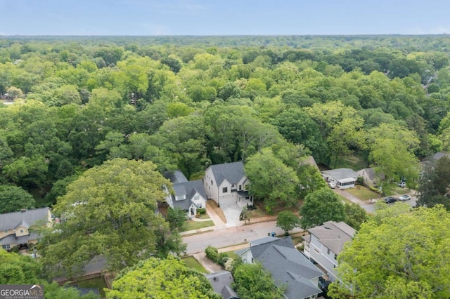 bird's eye view featuring a forest view and a residential view