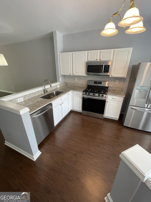 211 Buckland Dr, Alpharetta, GA 30022 - kitchen featuring appliances with stainless steel finishes, a sink, white cabinetry, and tasteful backsplash