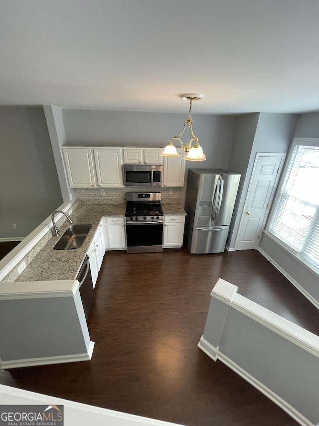 211 Buckland Dr, Alpharetta, GA 30022 - kitchen featuring stainless steel appliances, a sink, dark wood-type flooring, white cabinets, and pendant lighting