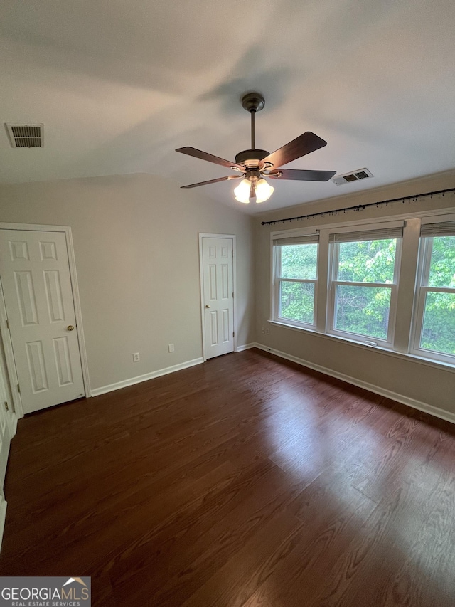 211 Buckland Dr, Alpharetta, GA 30022 - unfurnished bedroom with baseboards, dark wood-style floors, and multiple windows