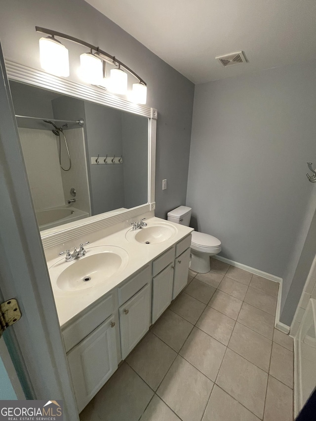211 Buckland Dr, Alpharetta, GA 30022 - bathroom featuring tile patterned floors, toilet, double vanity, tub / shower combination, and baseboards